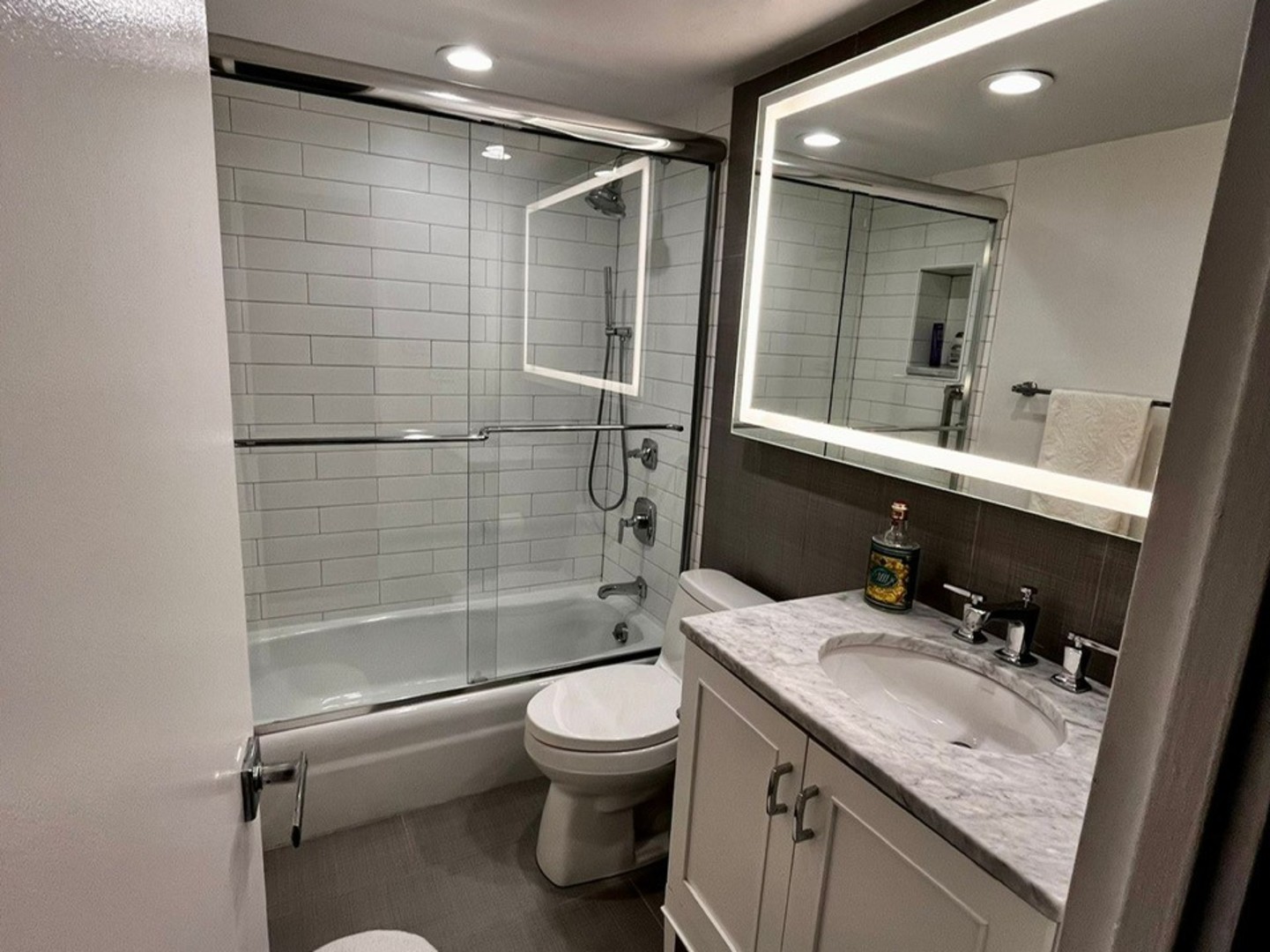 175 East Delaware Place, Unit 4603 Chicago, IL 60611 - Photo 13 of 17 a bathroom with a granite countertop sink toilet and shower