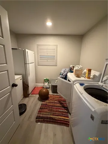 a kitchen with a refrigerator and a stove