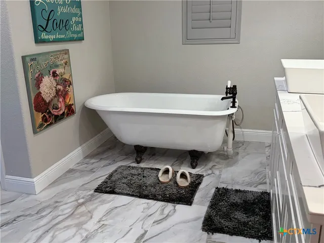 a bathroom with a bathtub and shower