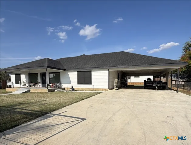a large house with a big yard and large trees