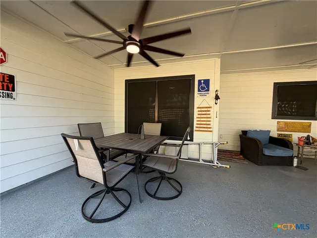 a view of a livingroom with furniture and a ceiling fan