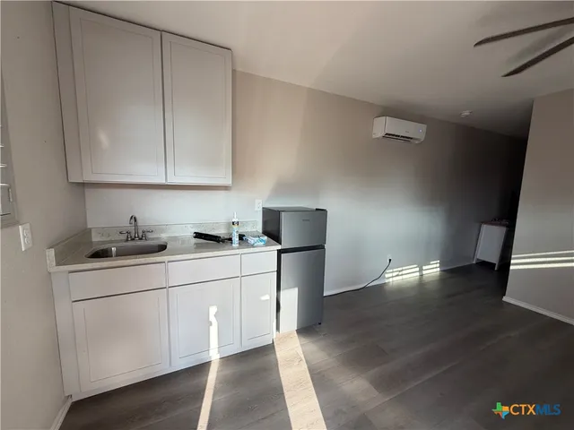 a kitchen with a sink cabinets and appliances