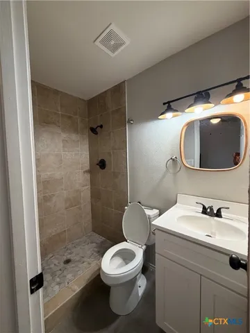 a bathroom with a sink toilet and shower