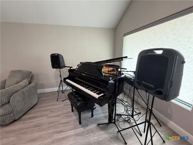 a living room with furniture and a piano