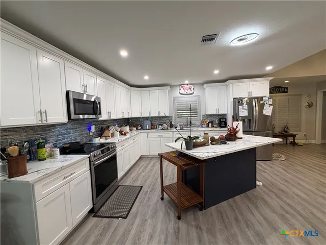 a kitchen with counter space cabinets and appliances