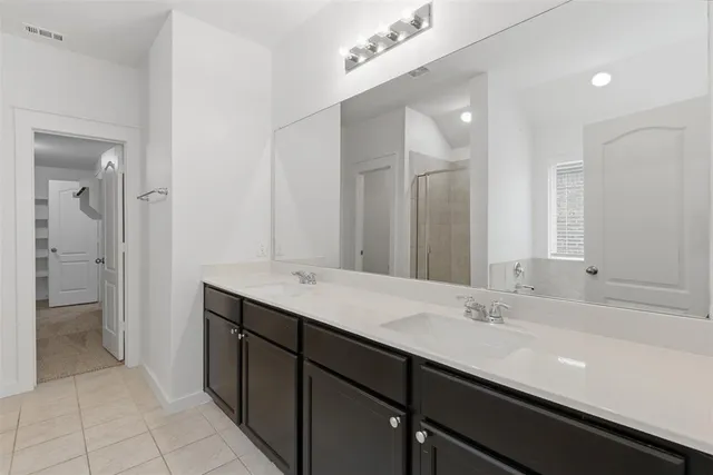 a bathroom with a double vanity sink and a mirror