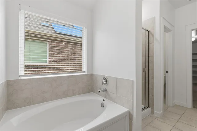a white bath tub sitting next to a window