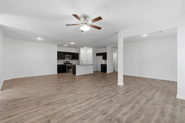 a view of a kitchen with a sink hardwood floor and a kitchen