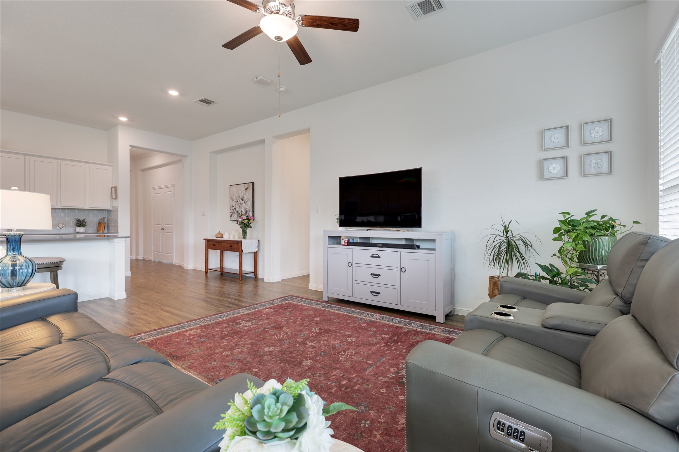 240 Prato Place Georgetown, TX 78628 - Photo 11 of 40 This living area features light-colored walls, hardwood flooring, and a ceiling fan
