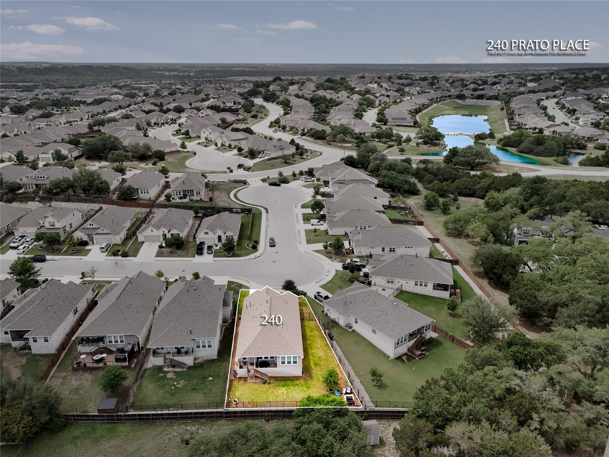 240 Prato Place Georgetown, TX 78628 - Photo 38 of 40 Aerial view of the property, showcasing its backyard and surrounding neighborhood with paved roads, other residences, and bodies of water