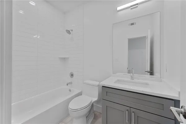 a bathroom with a sink a toilet and a bathtub