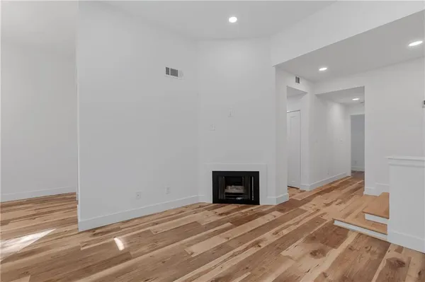 a view of empty room with a fireplace