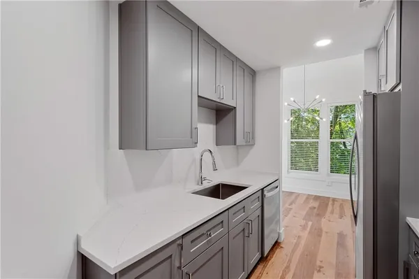 a kitchen with a sink a counter top space and cabinets