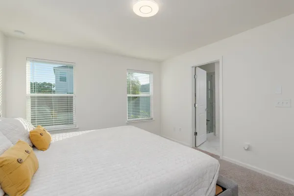 a bedroom with a bed and window