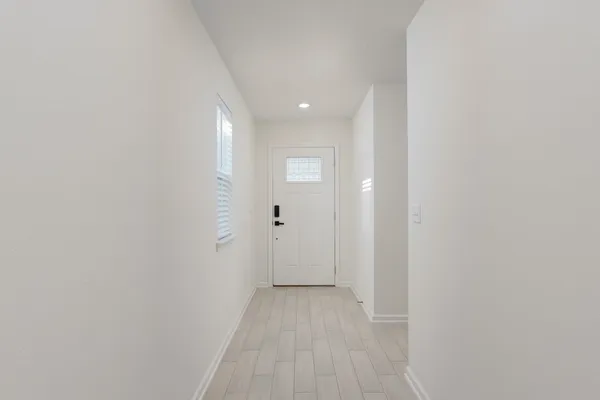 a view of a hallway with wooden floor