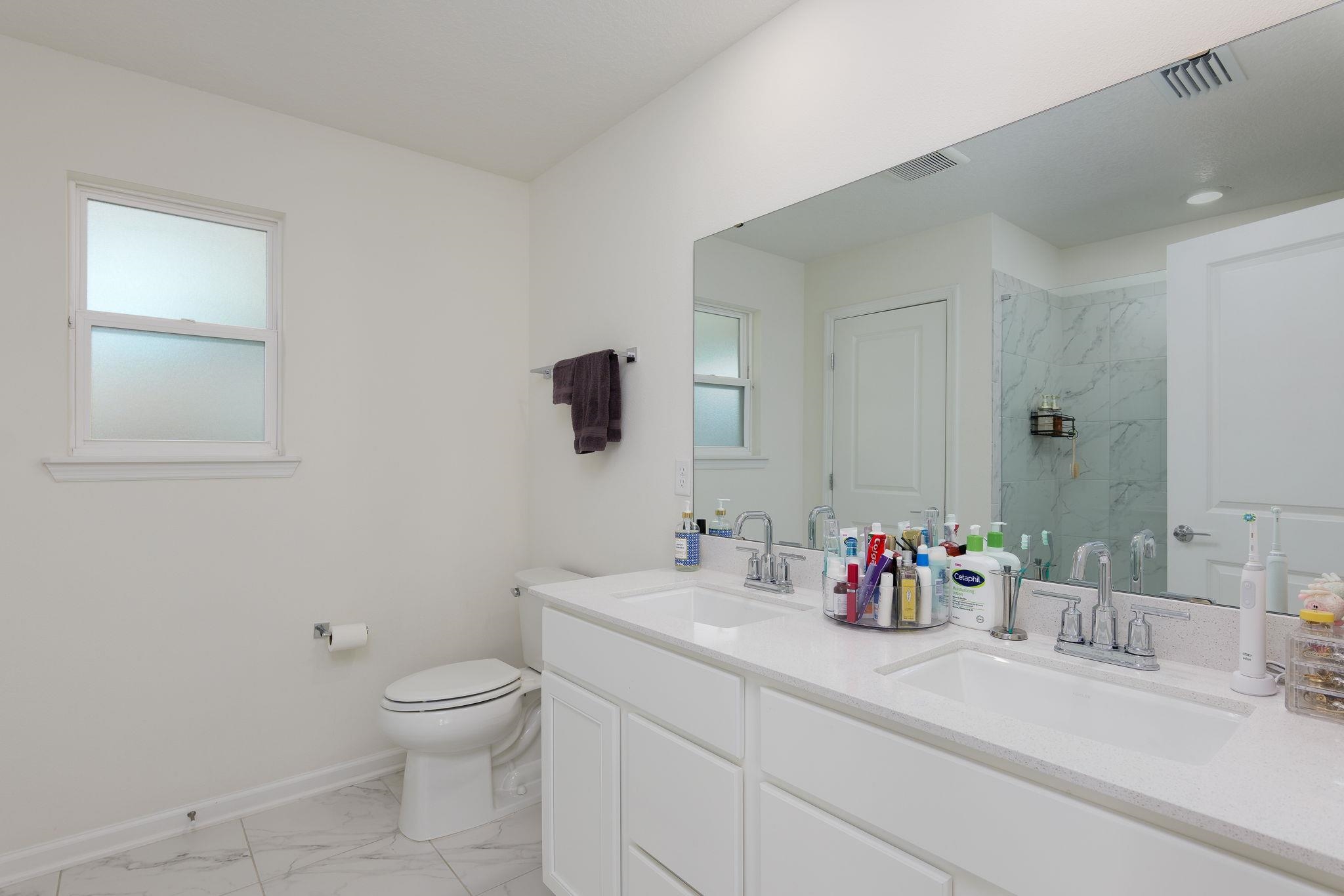 28 Peace River Road St. Johns, FL 32259 - Photo 18 of 42 a bathroom with a sink mirror and toilet