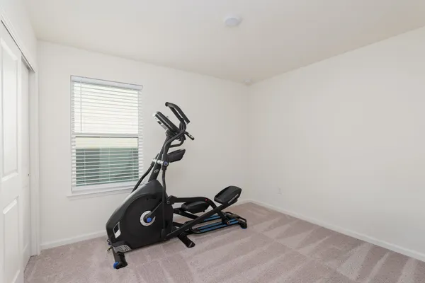 a room with gym equipment and a window