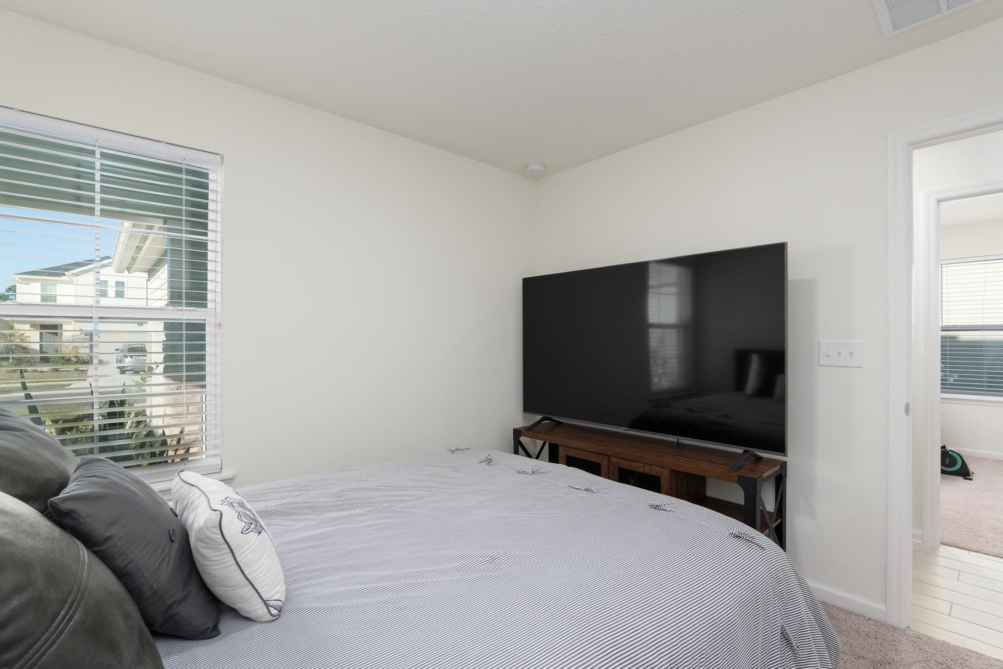 28 Peace River Road St. Johns, FL 32259 - Photo 28 of 42 a bedroom with a bed and a flat screen tv