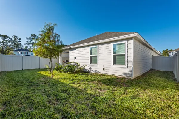 a view of a house with a backyard