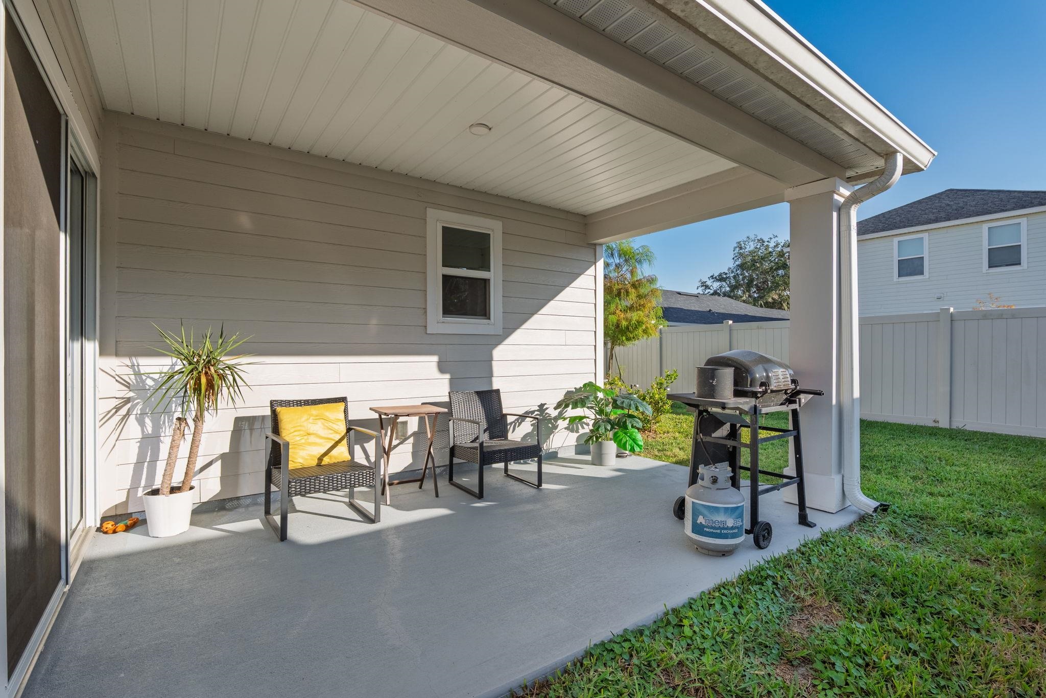 28 Peace River Road St. Johns, FL 32259 - Photo 30 of 42 a view of a patio with table and chairs and a barbeque