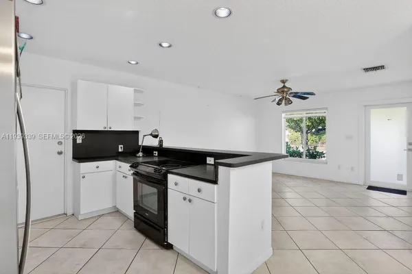 a kitchen with stainless steel appliances a stove a sink and a refrigerator