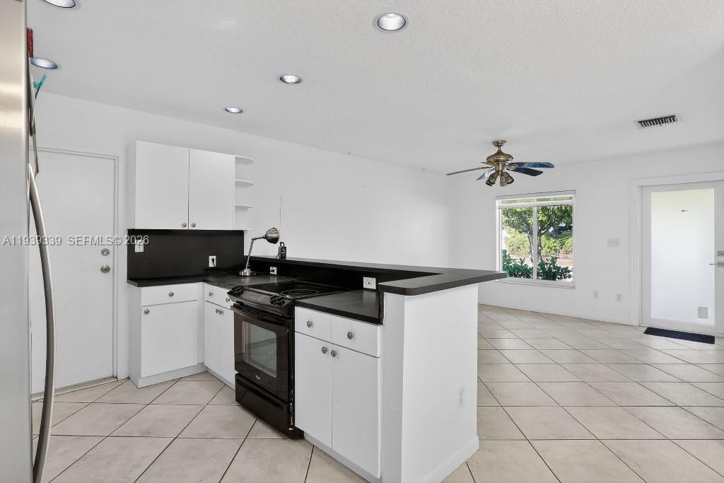 9900 Southwest 164th Terrace Miami, FL 33157 - Photo 13 of 44 a kitchen with stainless steel appliances a stove a sink and a refrigerator