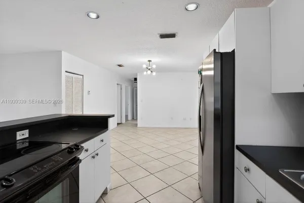 a kitchen with stainless steel appliances a refrigerator and a stove