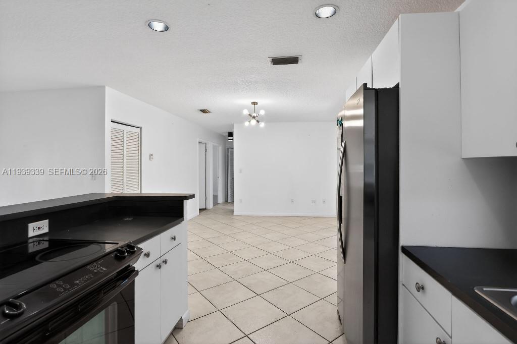 9900 Southwest 164th Terrace Miami, FL 33157 - Photo 15 of 44 a kitchen with stainless steel appliances a refrigerator and a stove