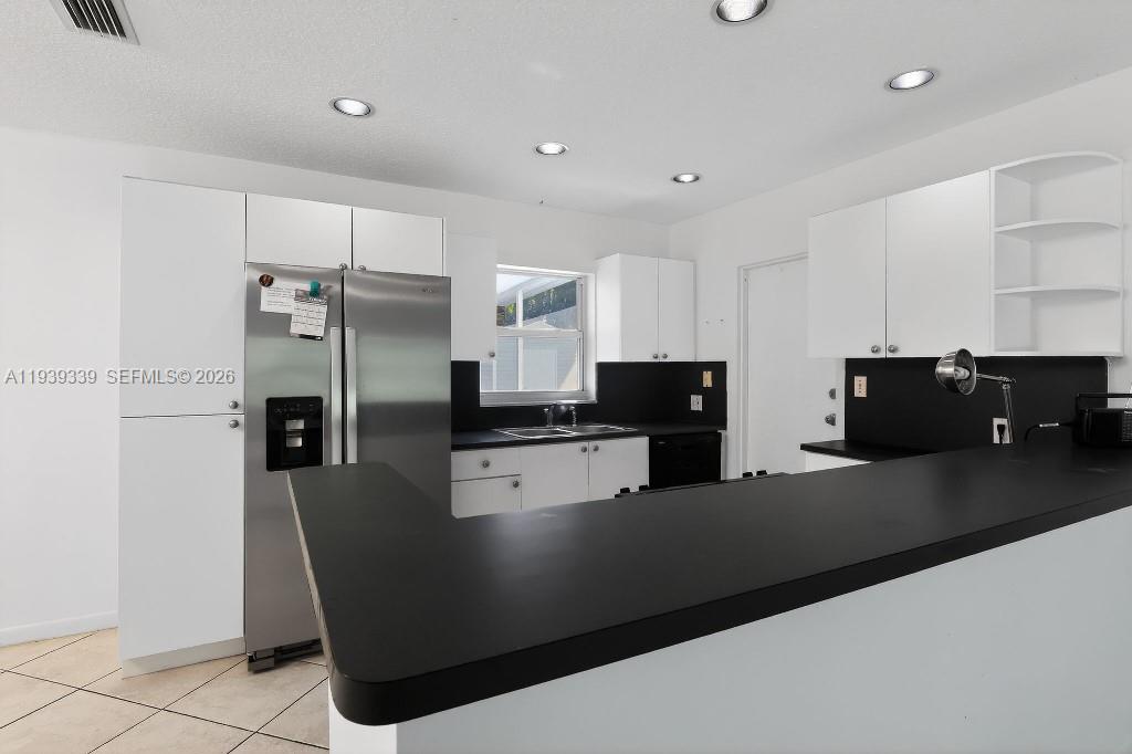 9900 Southwest 164th Terrace Miami, FL 33157 - Photo 16 of 44 a kitchen with stainless steel appliances granite countertop a refrigerator a stove a sink and a refrigerator