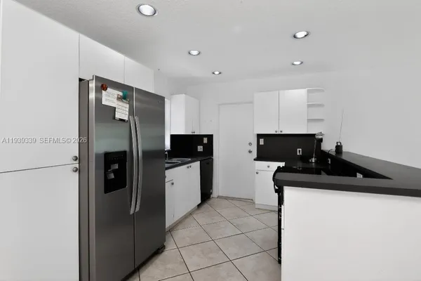 a kitchen with stainless steel appliances a refrigerator sink and stove