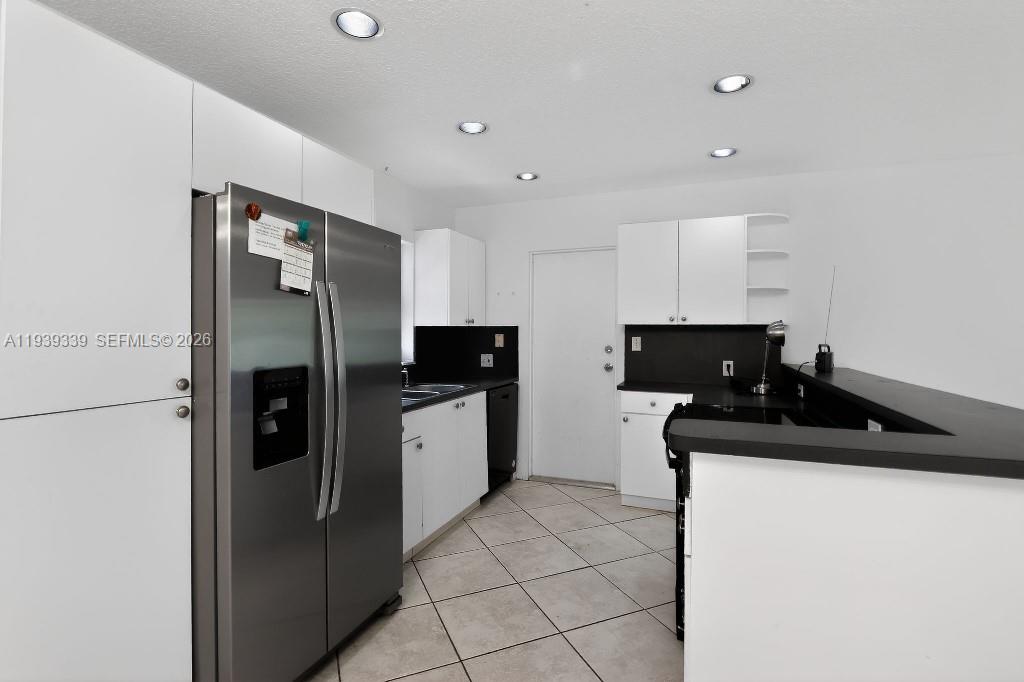 9900 Southwest 164th Terrace Miami, FL 33157 - Photo 17 of 44 a kitchen with stainless steel appliances a refrigerator sink and stove