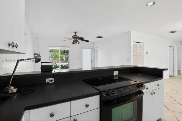 a kitchen with a sink a stove and a window
