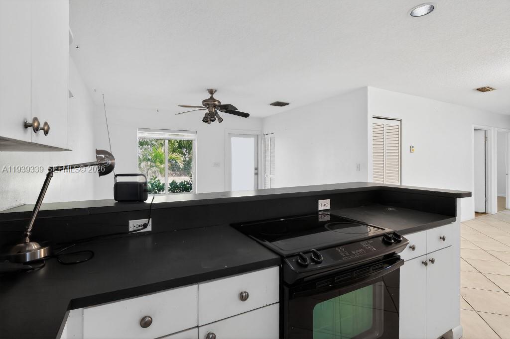 9900 Southwest 164th Terrace Miami, FL 33157 - Photo 19 of 44 a kitchen with a sink a stove and a window
