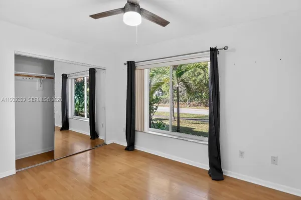 wooden floor in an empty room with a window