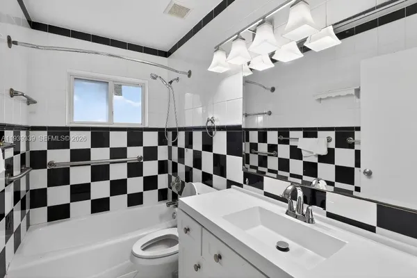 a bathroom with a shower a toilet and sink