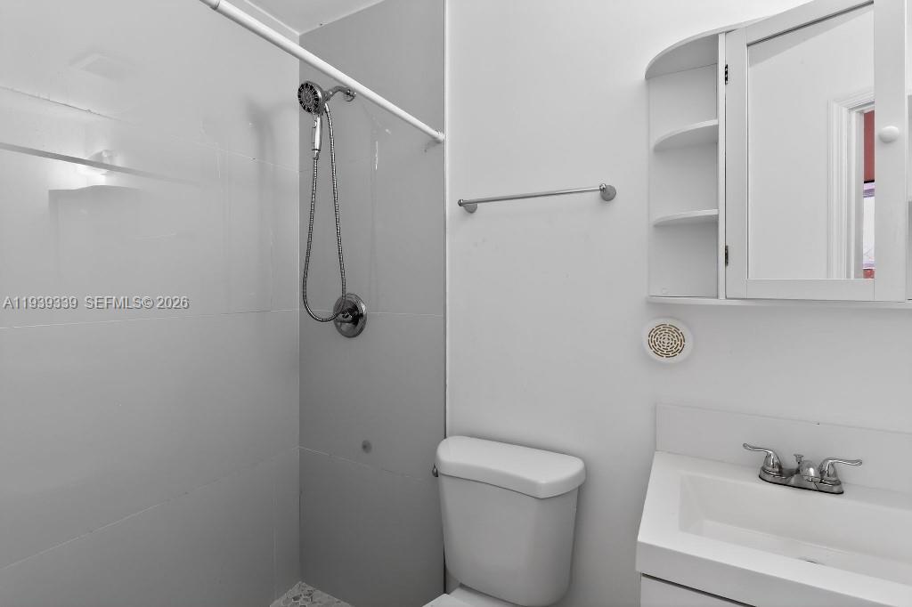 9900 Southwest 164th Terrace Miami, FL 33157 - Photo 26 of 44 a bathroom with a shower a toilet and sink
