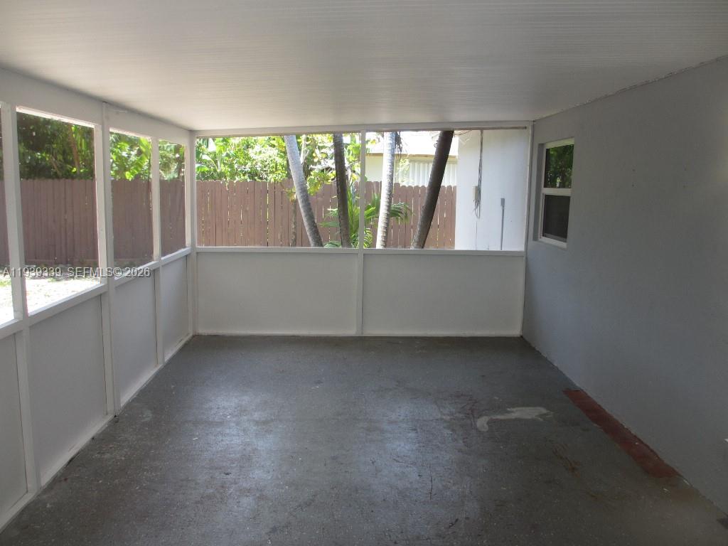 9900 Southwest 164th Terrace Miami, FL 33157 - Photo 31 of 44 an empty room with wooden floor and windows
