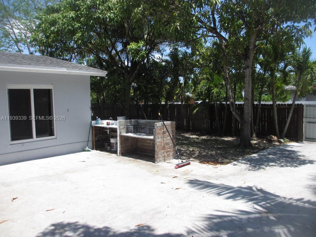 9900 Southwest 164th Terrace Miami, FL 33157 - Photo 33 of 44 a white house that has tree in front of it