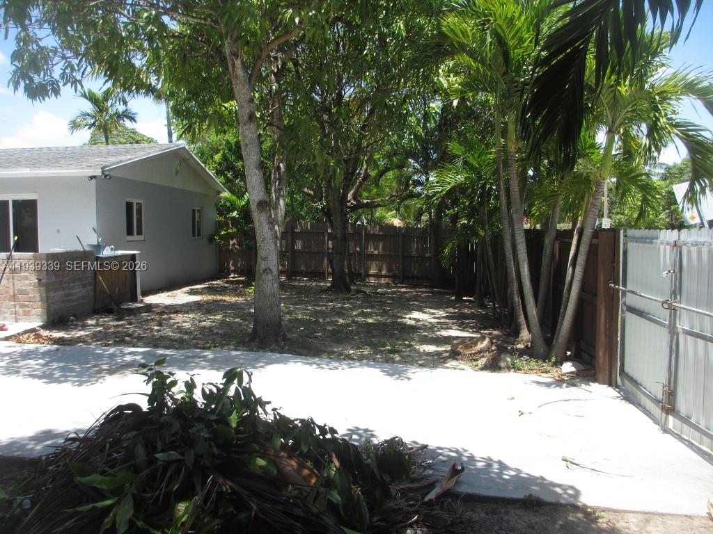 9900 Southwest 164th Terrace Miami, FL 33157 - Photo 37 of 44 a view of a yard with plants and trees
