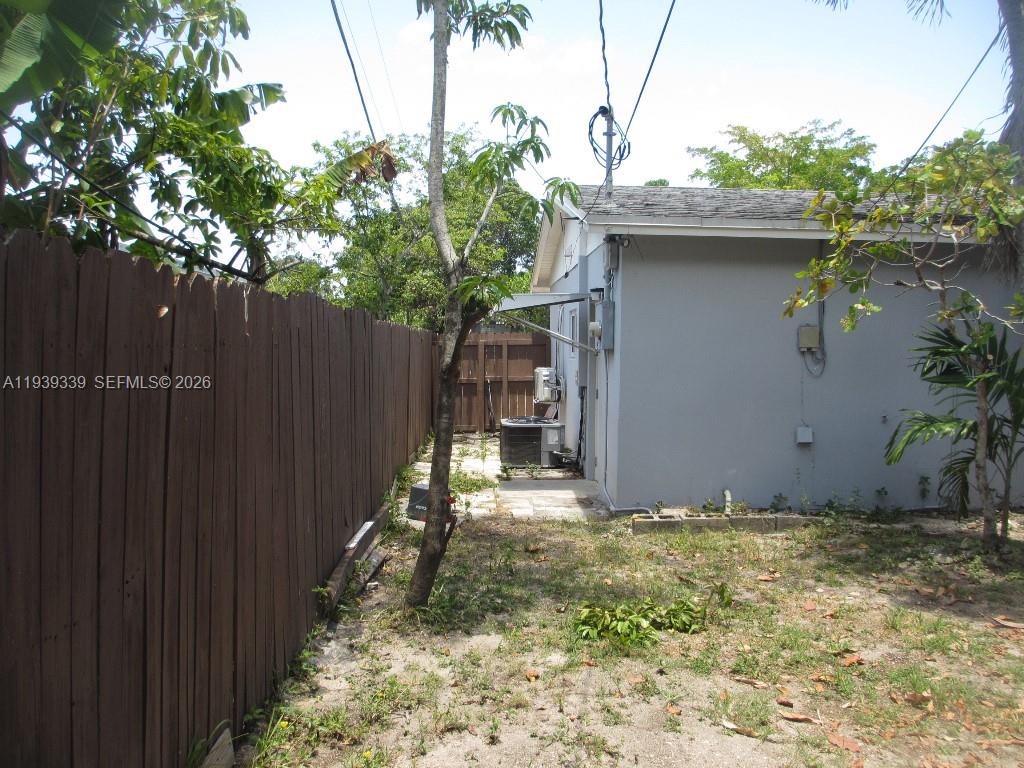 9900 Southwest 164th Terrace Miami, FL 33157 - Photo 41 of 44 a backyard of a house with lots of green space