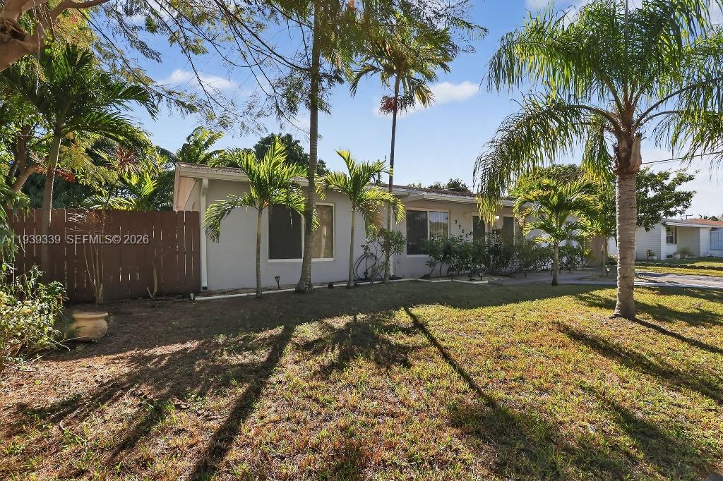 9900 Southwest 164th Terrace Miami, FL 33157 - Photo 6 of 44 a front view of a house with a yard
