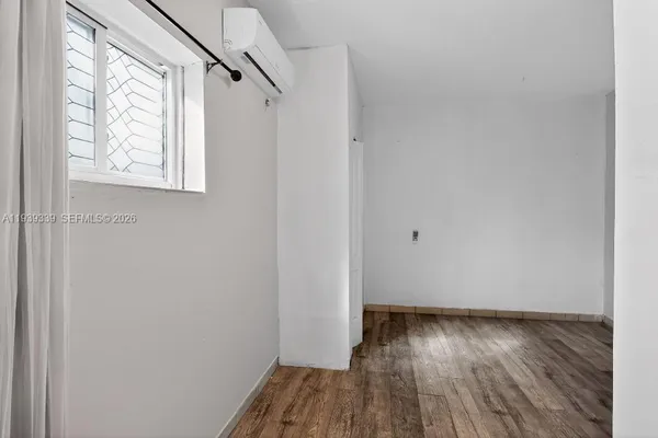 a view of small space with wooden floor and windows