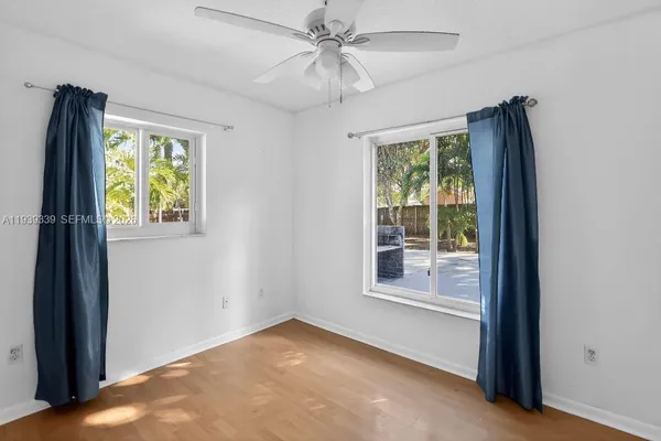 an empty room with windows and closet