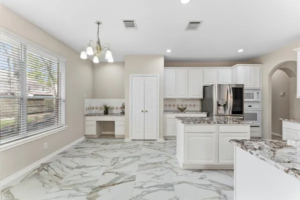 a view of a yard with plants and trees