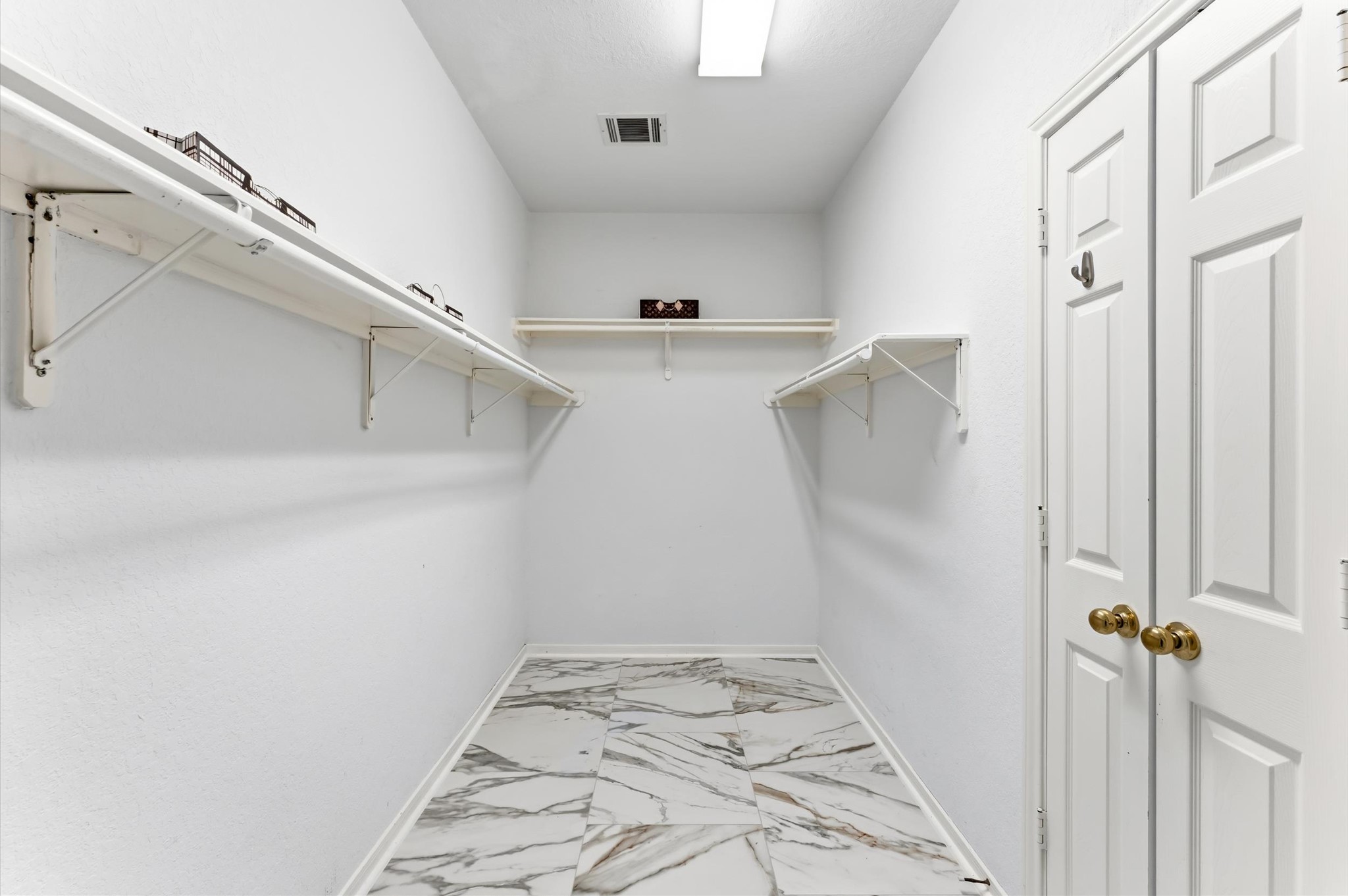91 South Downy Willow Circle Spring, TX 77382 - Photo 24 of 50 a view of a hallway with a white walls and a window