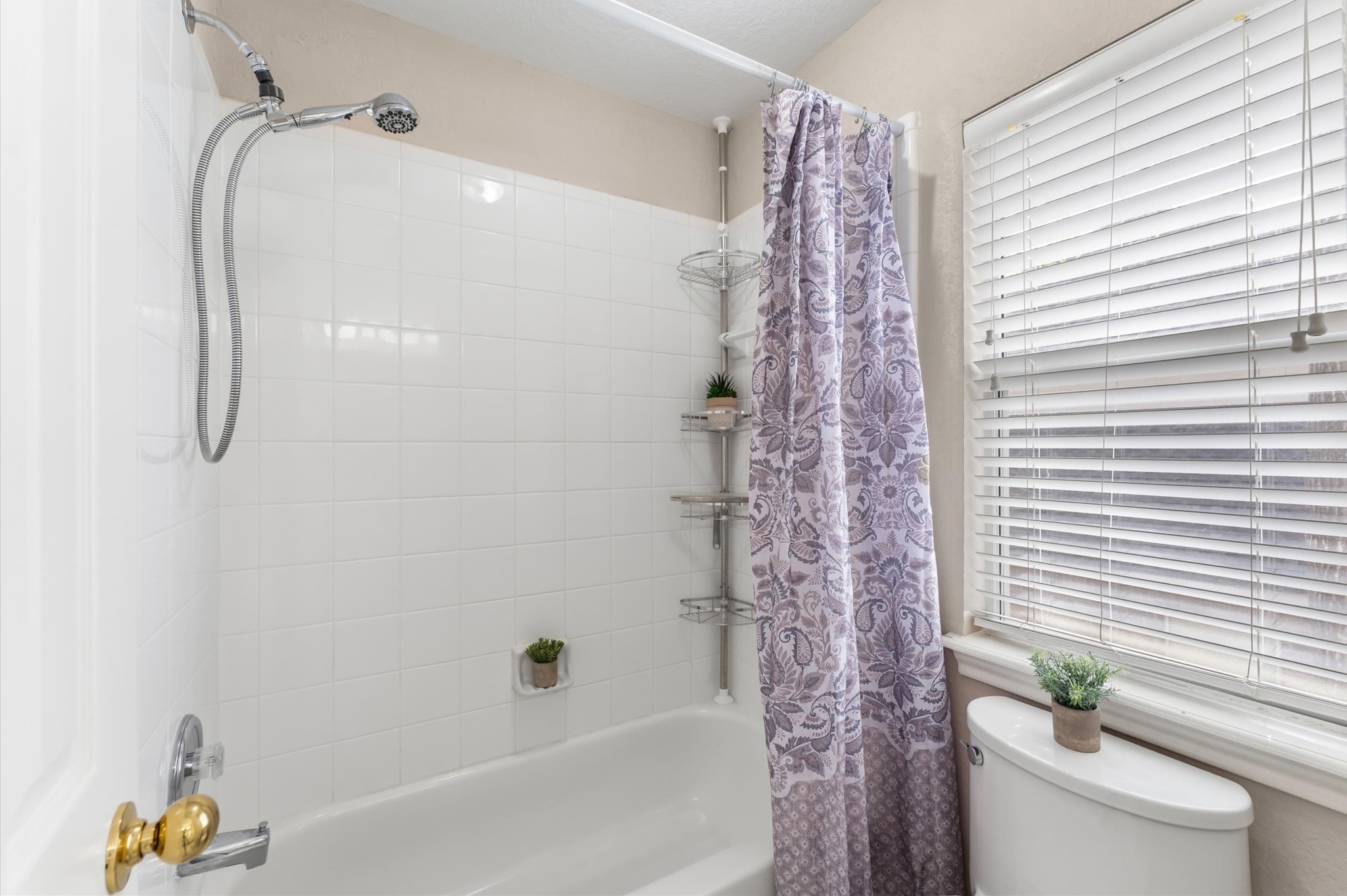91 South Downy Willow Circle Spring, TX 77382 - Photo 31 of 50 a bathroom with a shower curtain and a sink
