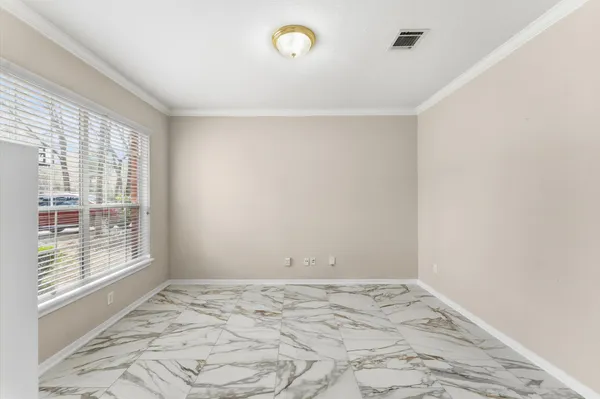 a kitchen with kitchen island granite countertop a sink stove refrigerator and white cabinets with wooden floor