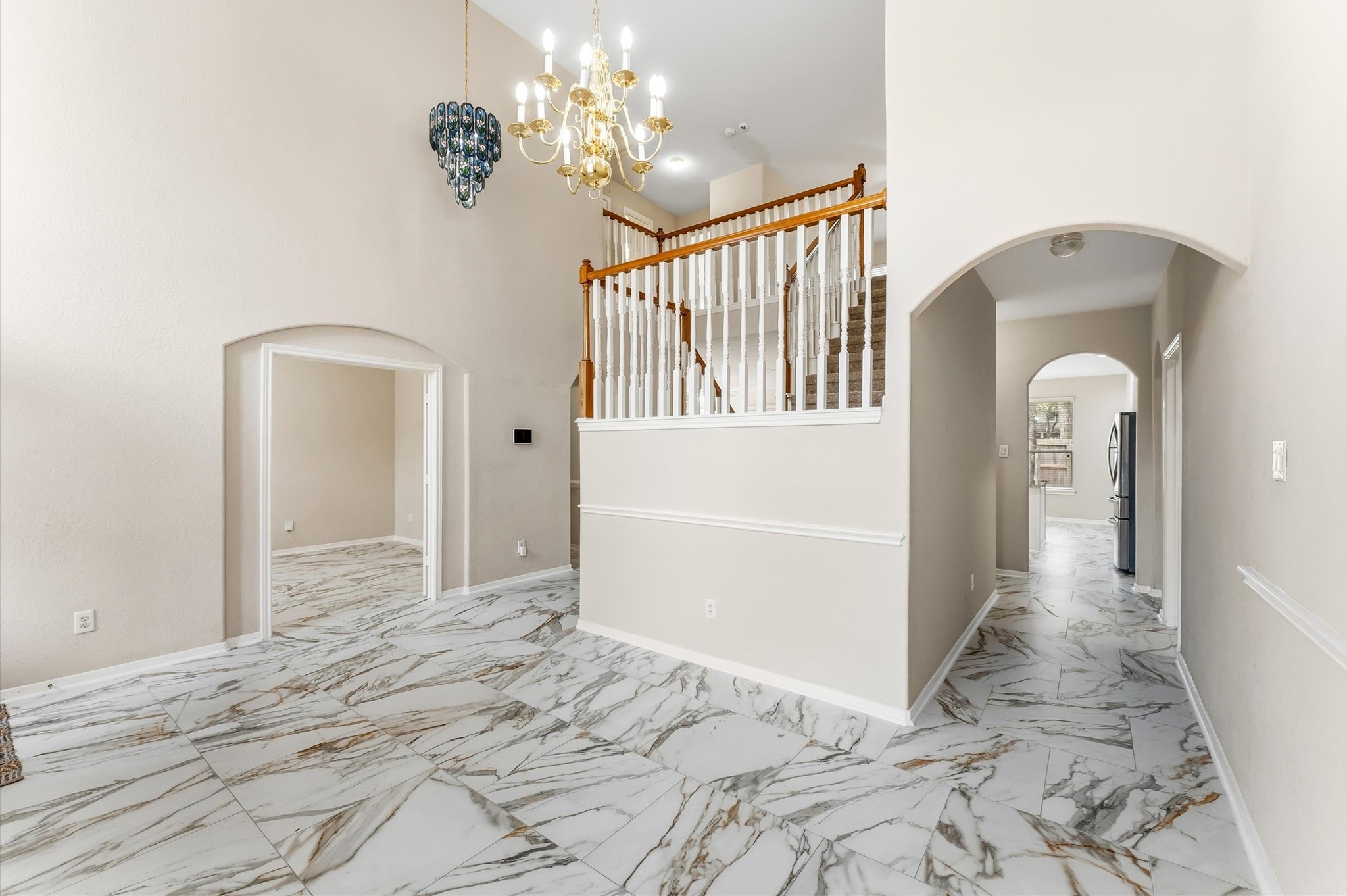 91 South Downy Willow Circle Spring, TX 77382 - Photo 9 of 50 a view of a hallway with wooden floor and chandelier