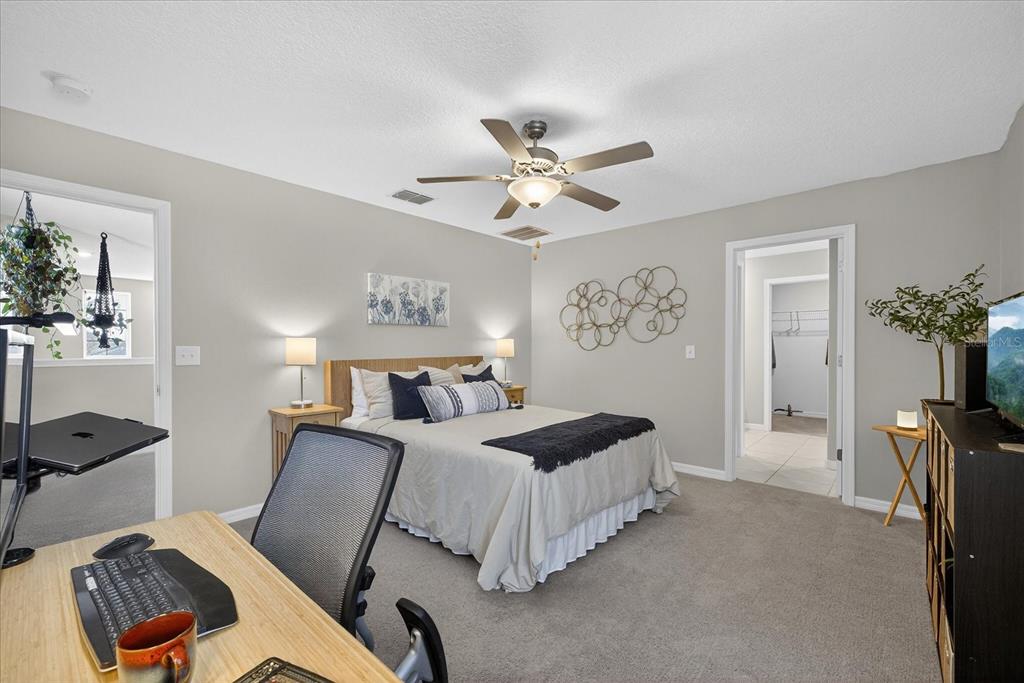 6115 Apple Snail Avenue New Port Richey, FL 34653 - Photo 15 of 59 a bedroom with a bed couch and a window