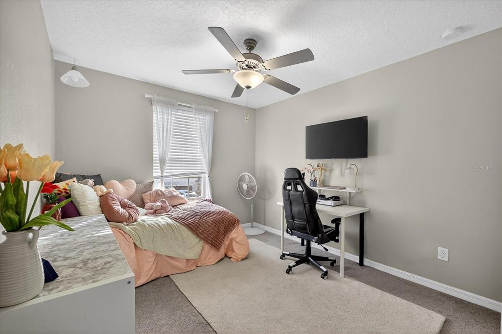 6115 Apple Snail Avenue New Port Richey, FL 34653 - Photo 20 of 59 a work room with furniture and a ceiling fan